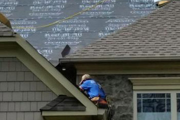 man laying roofing